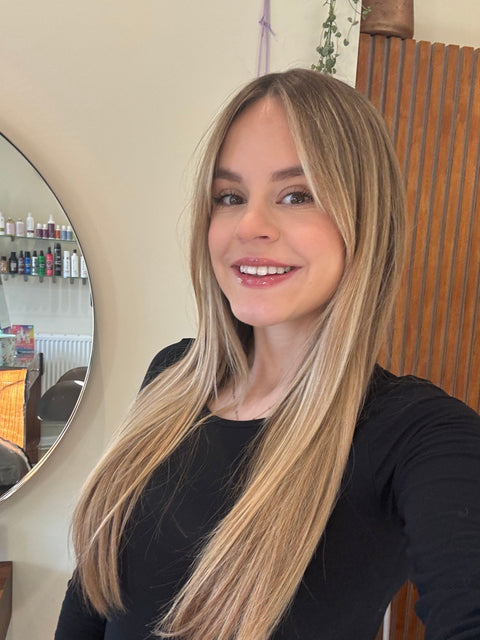 Hairdresser called Ellie with long blonde hair in a salon setting
